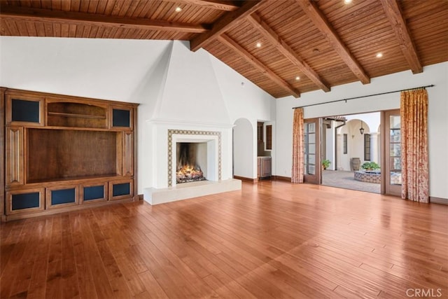 unfurnished living room with wood ceiling, a fireplace, hardwood / wood-style flooring, and high vaulted ceiling