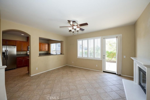 unfurnished living room featuring ceiling fan