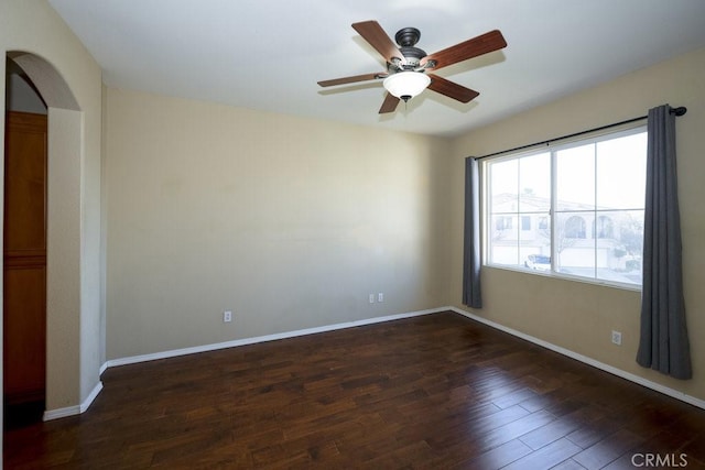 unfurnished room featuring ceiling fan and dark hardwood / wood-style flooring