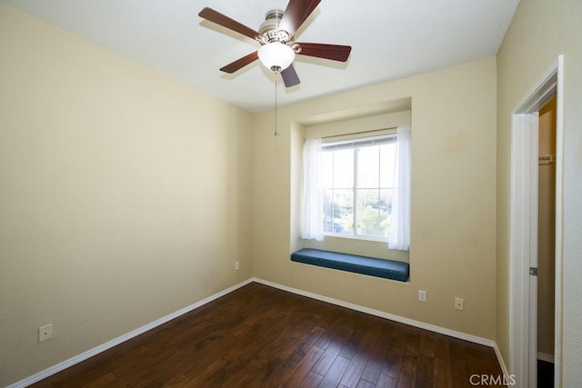 empty room featuring ceiling fan and dark wood-type flooring