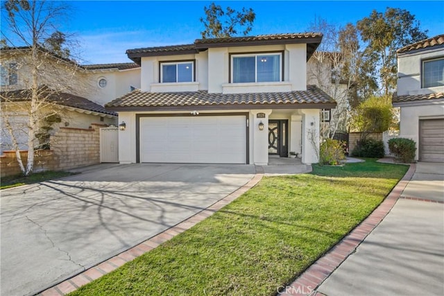 mediterranean / spanish-style home featuring a front yard and a garage