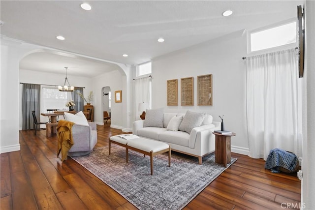 living room featuring dark hardwood / wood-style floors and a chandelier