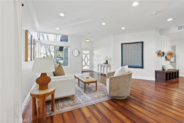 living room with wood-type flooring and ornamental molding