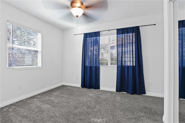 spare room featuring carpet and ceiling fan