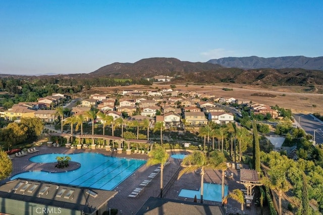 community pool with a residential view and a mountain view