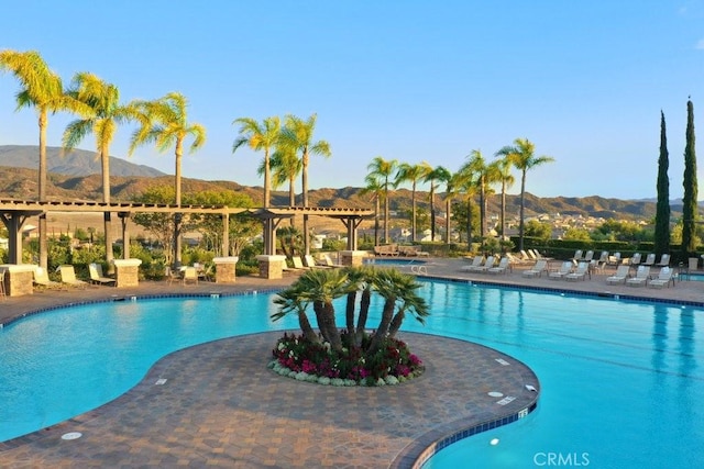 pool featuring a patio and a mountain view