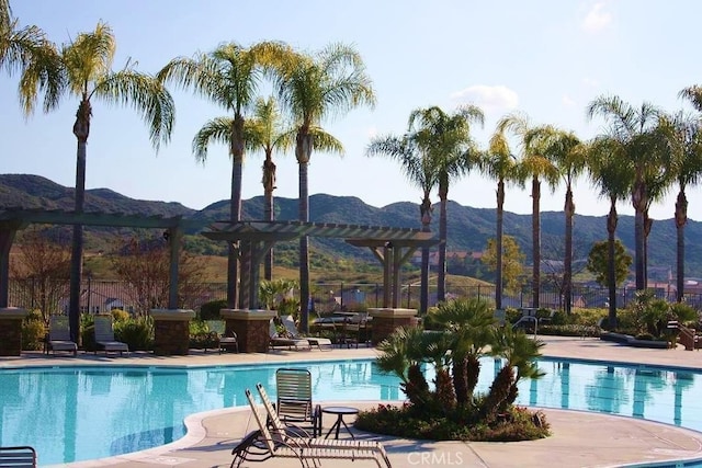 view of swimming pool featuring a pergola, a patio area, and a mountain view