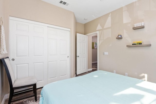 bedroom with a closet and visible vents