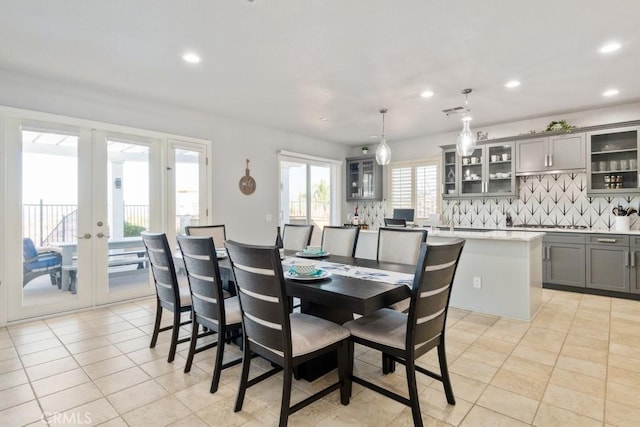 dining area with light tile patterned floors and french doors