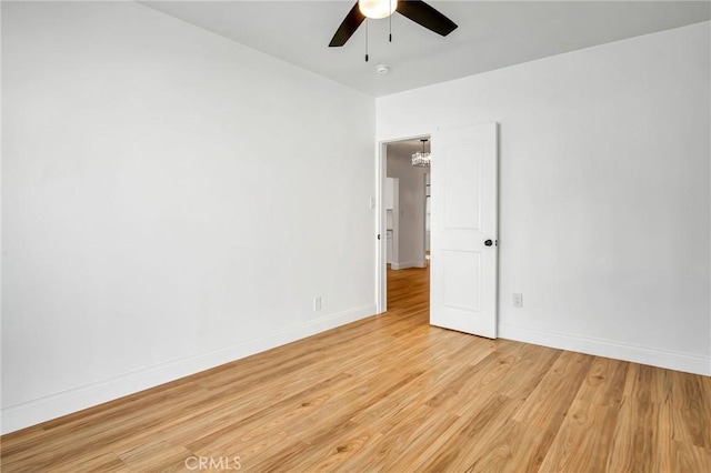 empty room featuring ceiling fan and light wood-type flooring