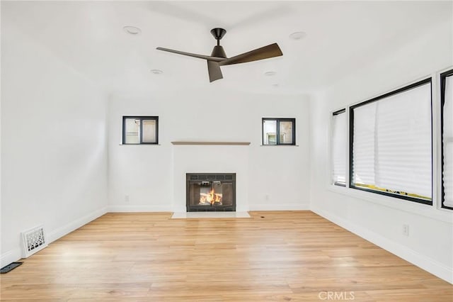 unfurnished living room with ceiling fan and light wood-type flooring