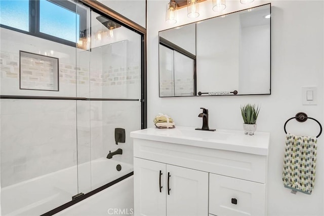 bathroom featuring vanity and shower / bath combination with glass door