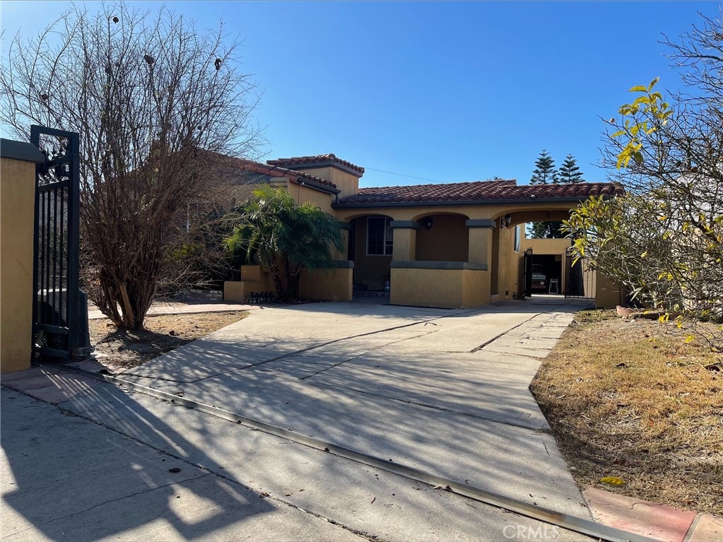 mediterranean / spanish house featuring a carport