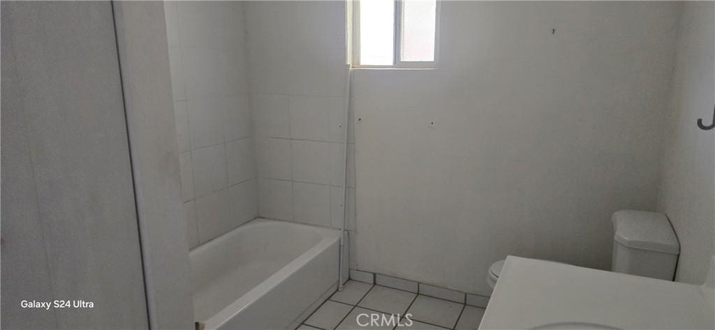 bathroom with toilet and tile patterned flooring