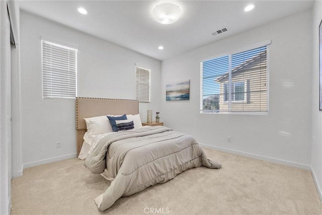 bedroom featuring light carpet