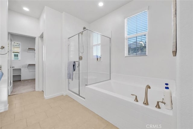 bathroom featuring tile patterned floors and separate shower and tub