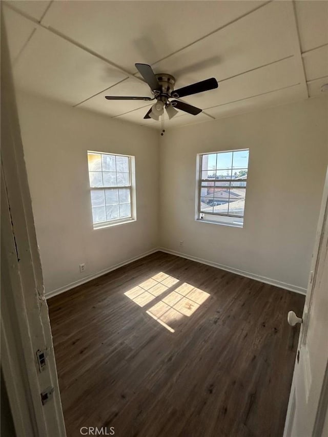 empty room featuring ceiling fan and dark hardwood / wood-style flooring