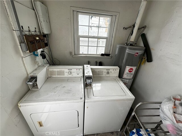 laundry area featuring water heater and separate washer and dryer