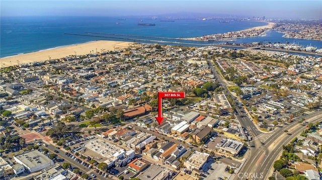 birds eye view of property featuring a view of the beach and a water view