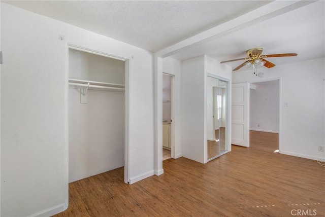 unfurnished bedroom with ceiling fan and hardwood / wood-style floors