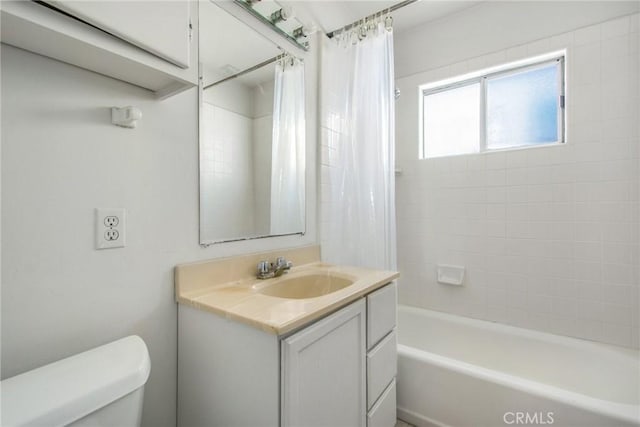 full bathroom featuring toilet, vanity, and shower / bath combination with curtain