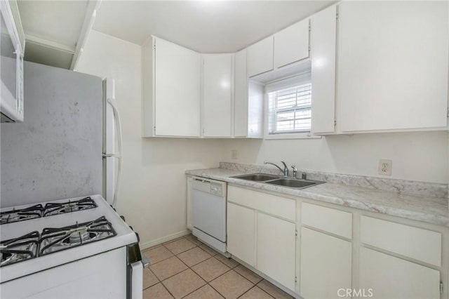 kitchen featuring white cabinets, light tile patterned floors, sink, and white appliances