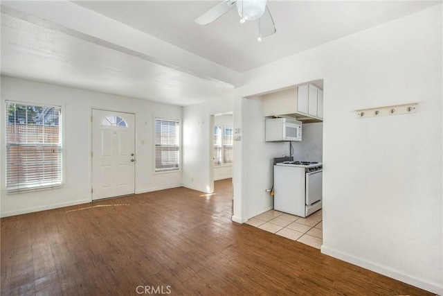 kitchen featuring ceiling fan, light wood-type flooring, white appliances, and white cabinetry