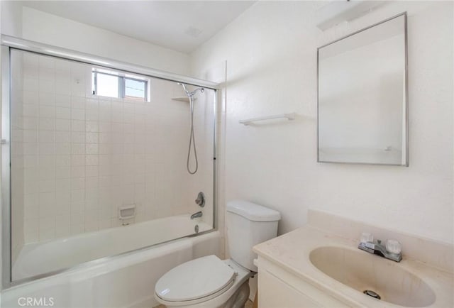 full bathroom with toilet, tiled shower / bath, and vanity