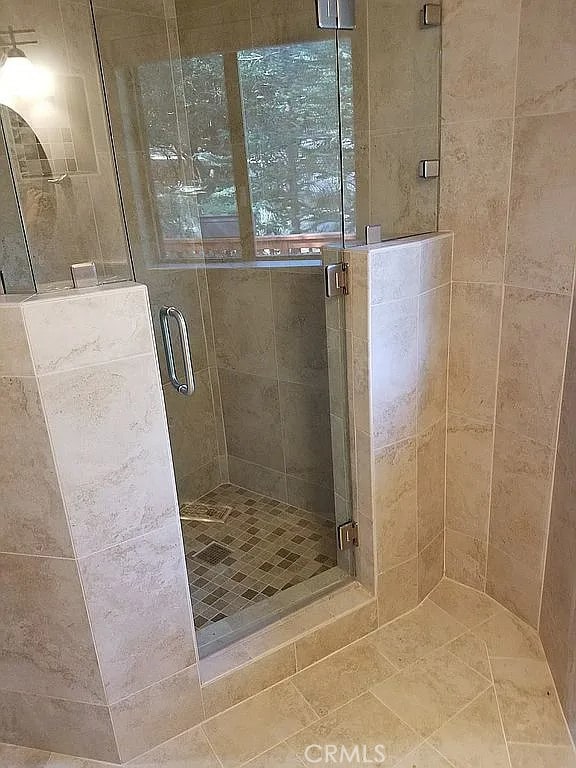 bathroom featuring a shower with door