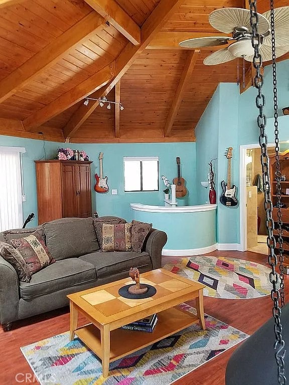 living room with ceiling fan, wooden ceiling, hardwood / wood-style floors, and vaulted ceiling with beams