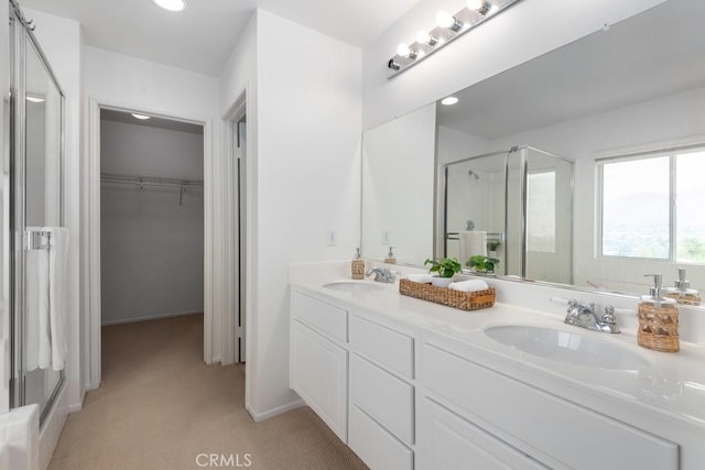 bathroom featuring vanity and a shower with door