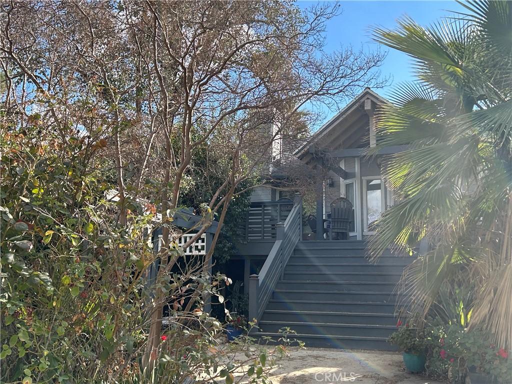 view of side of property featuring stairs and a deck