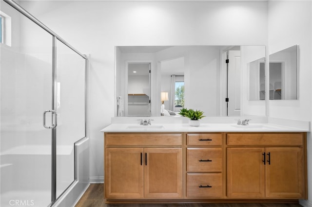 bathroom featuring vanity, wood-type flooring, and walk in shower