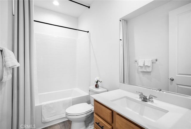 full bathroom with vanity, wood-type flooring, tub / shower combination, and toilet