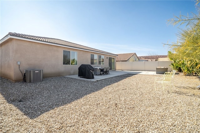 rear view of property with central AC and a patio