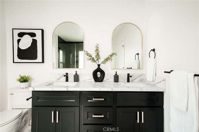 bathroom featuring toilet and vanity