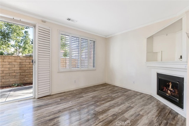 unfurnished living room with crown molding and wood-type flooring