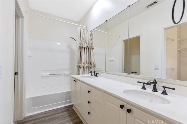 bathroom featuring shower / tub combo, wood-type flooring, and vanity