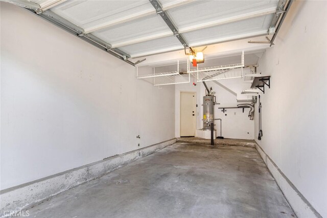 garage featuring a garage door opener and strapped water heater