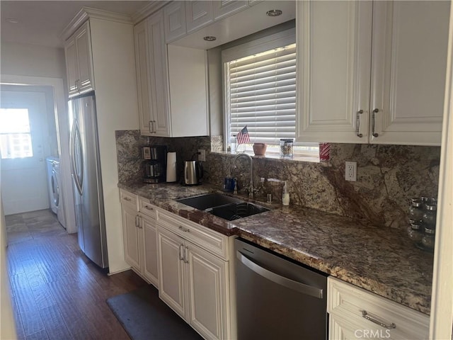 kitchen with stainless steel appliances, a healthy amount of sunlight, decorative backsplash, white cabinets, and sink