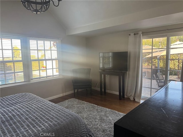 bedroom with vaulted ceiling, dark wood-type flooring, a chandelier, and access to outside