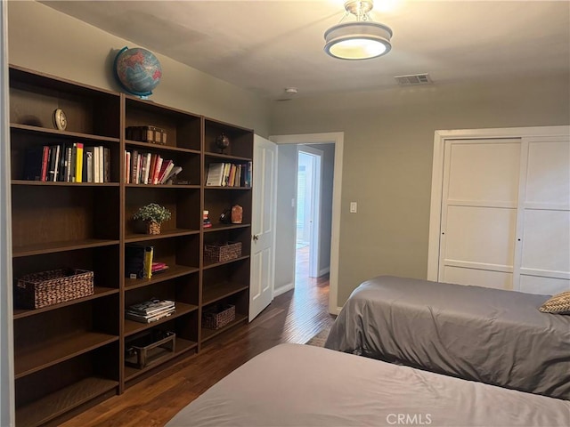 bedroom with dark hardwood / wood-style floors