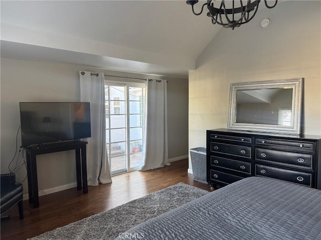 bedroom featuring dark wood-type flooring, access to outside, a notable chandelier, and vaulted ceiling