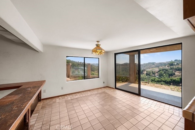 interior space with light tile patterned floors and plenty of natural light