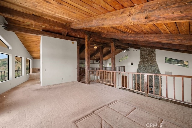 carpeted spare room with wooden ceiling and lofted ceiling with beams