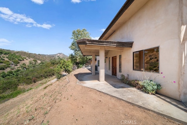 exterior space featuring a patio area and a mountain view