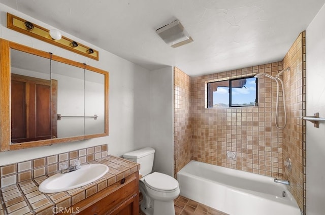 full bathroom with tiled shower / bath, tile patterned floors, vanity, decorative backsplash, and toilet