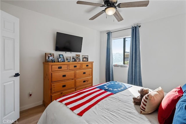 bedroom with ceiling fan and light hardwood / wood-style floors