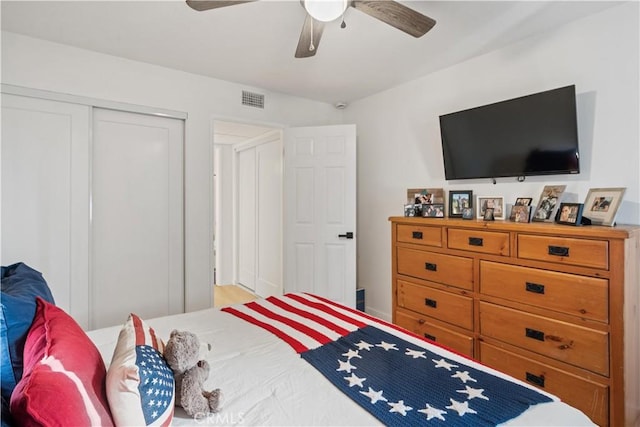 bedroom with ceiling fan and a closet