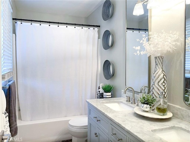 bathroom with toilet, shower / bathtub combination with curtain, double vanity, and a sink